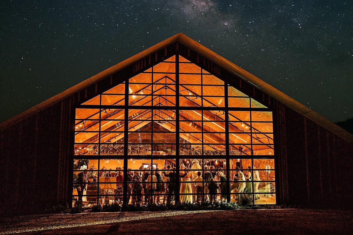 The barn glowing under a starry night sky
