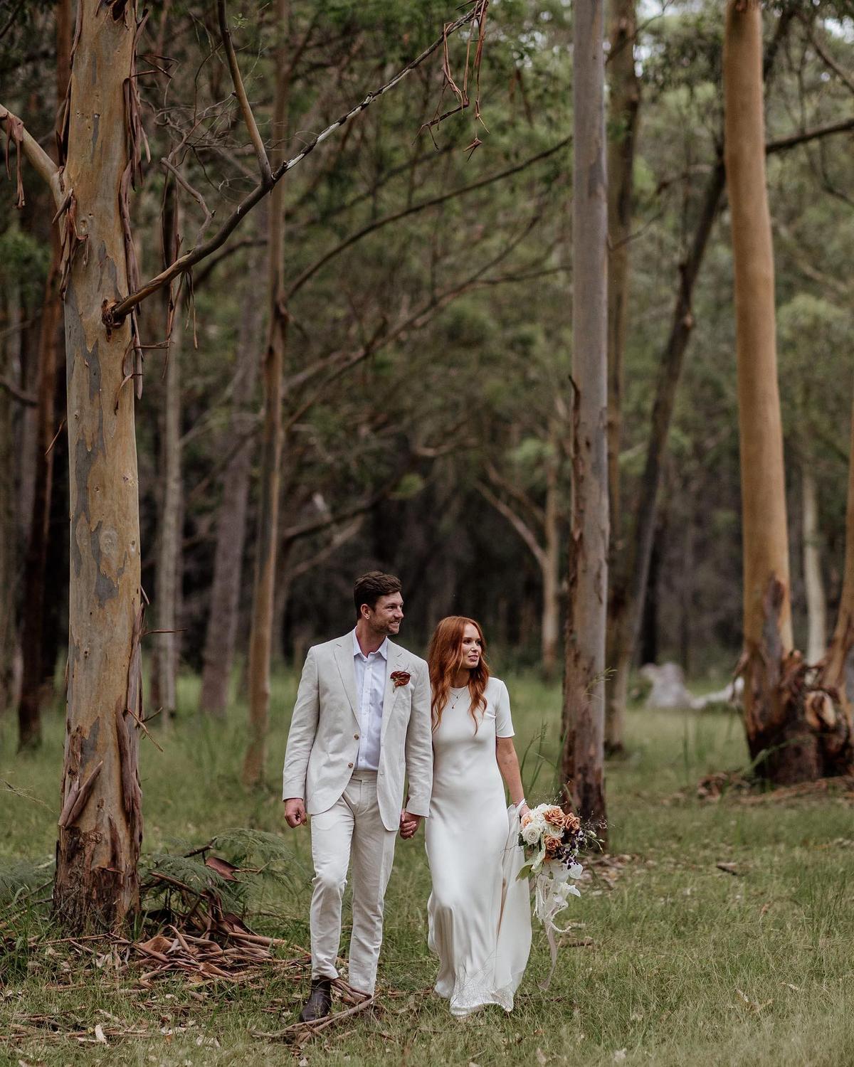 A couple walking through the tall gums
