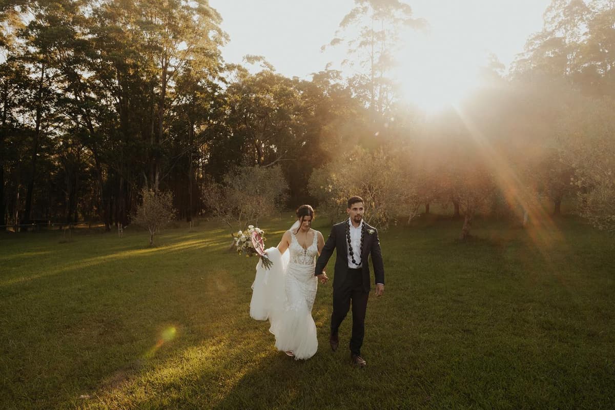 A couple walking the paddock in golden evening light