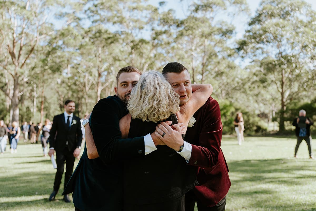 Guests sharing a hug on the lawn