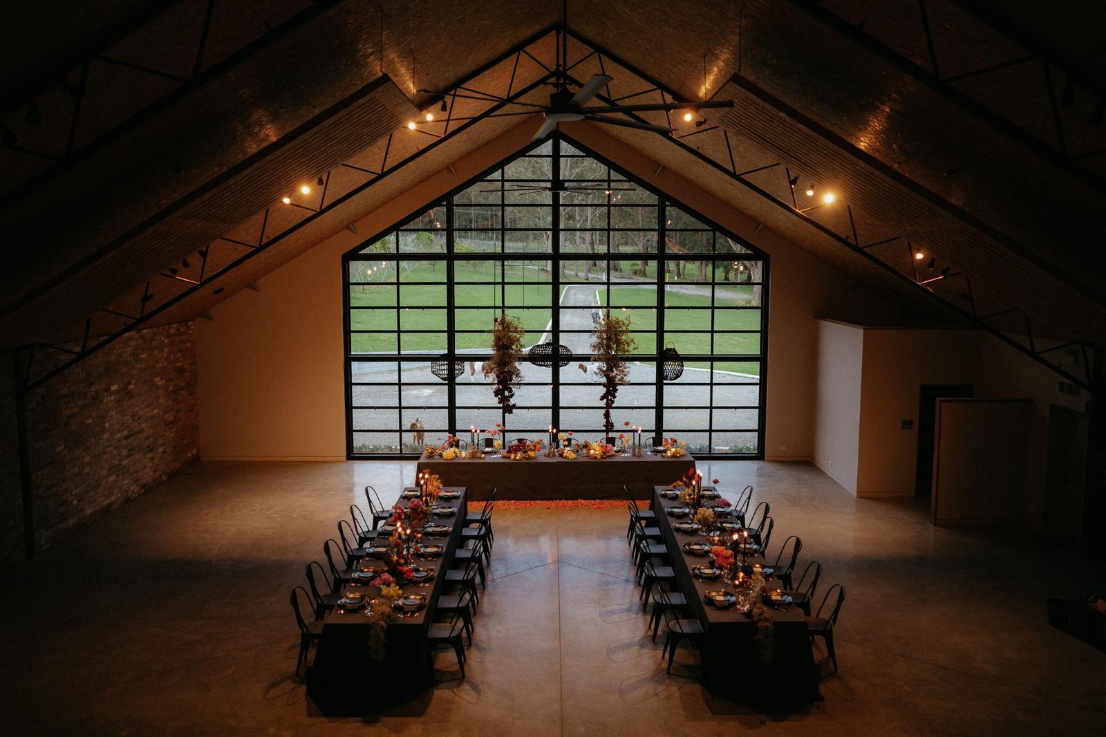 The barn at dusk, strung with fairy lights