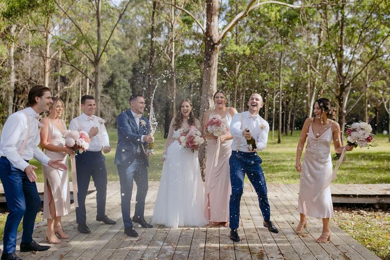 The bridal party celebrating on the deck among the gums