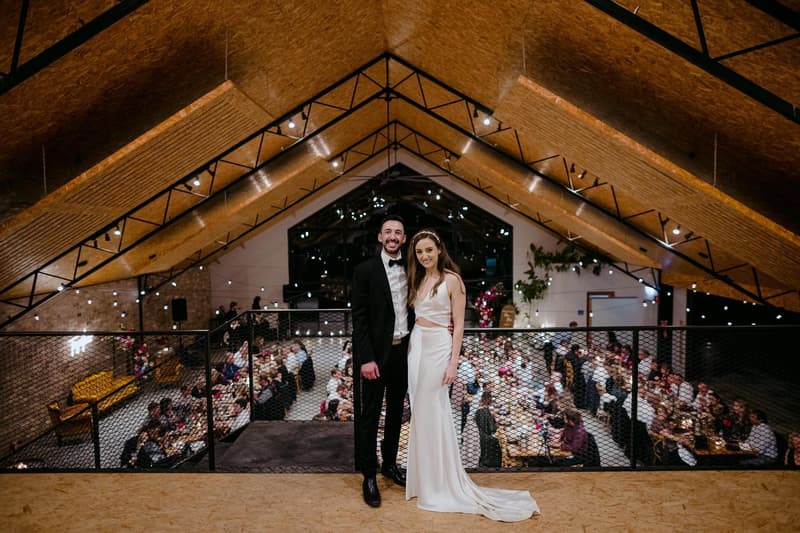A couple inside the barn above their reception