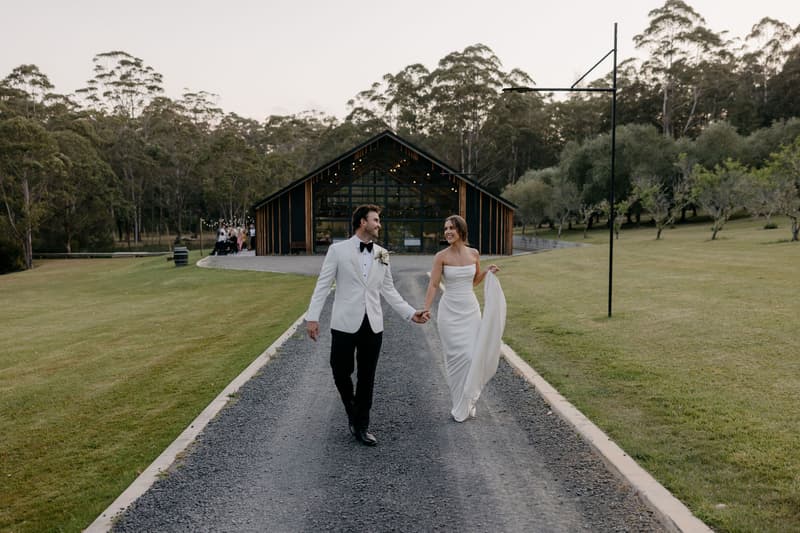 A couple walking the estate driveway at dusk